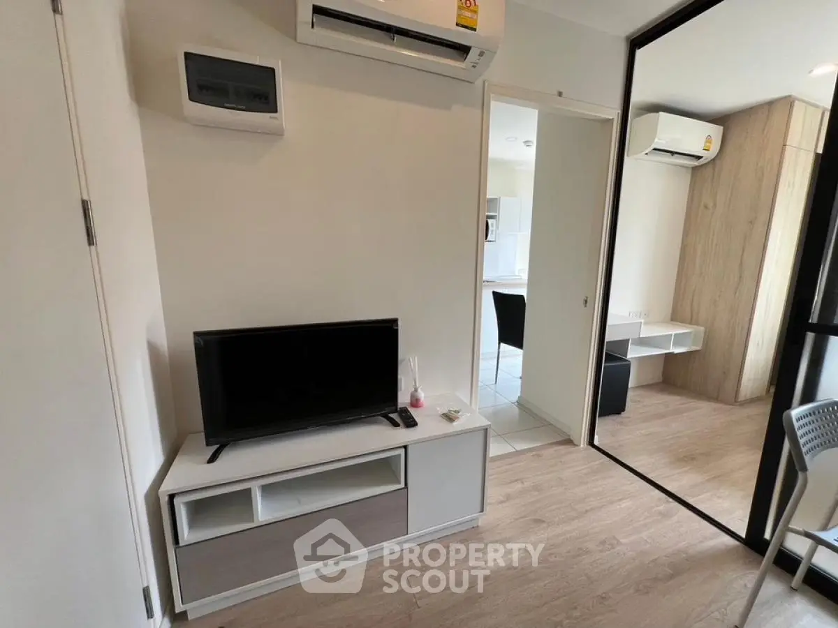 Modern living room with sleek TV stand and air conditioning in stylish apartment