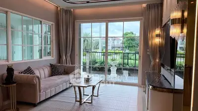Luxurious living room with elegant decor and large windows offering a stunning garden view.