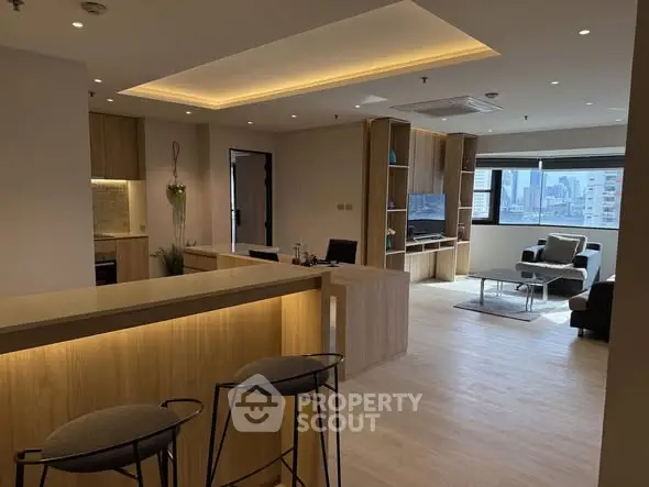 Modern open-plan living room with stylish furniture and city view.