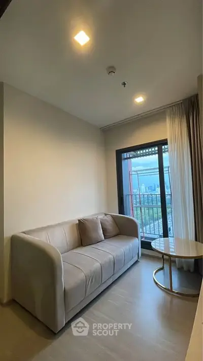 Cozy living room with modern sofa and balcony view in urban apartment