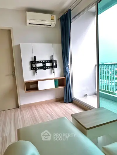 Modern living room with balcony and air conditioning, featuring sleek wooden flooring and TV mount.