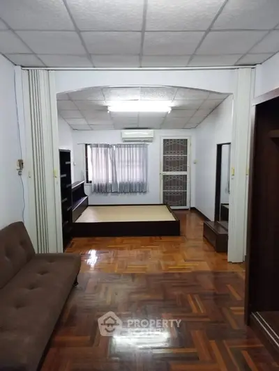 Spacious living room with parquet flooring and modern furniture