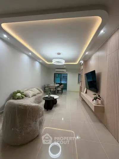 Modern living room with elegant lighting and sleek furniture in a contemporary apartment.