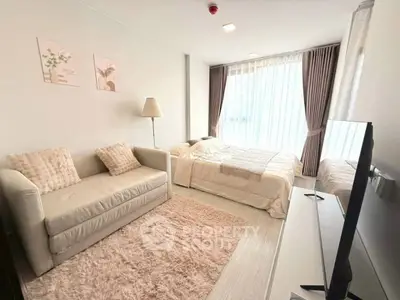 Modern bedroom with cozy sofa and large window in stylish apartment