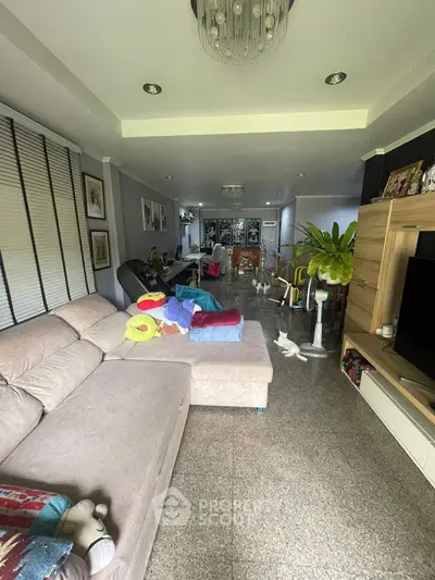 Spacious living room with modern decor and ample natural light