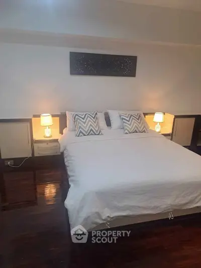 Cozy bedroom with elegant decor and ambient lighting, perfect for relaxation.