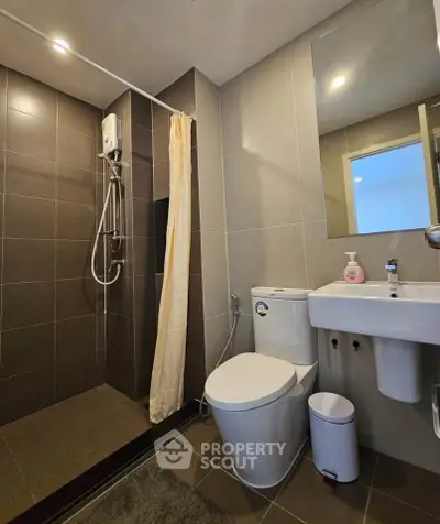 Modern bathroom with sleek shower and contemporary fixtures in stylish apartment.