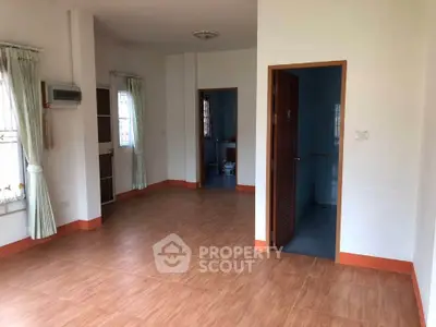 Spacious unfurnished room with wooden flooring and natural light