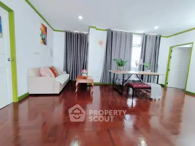 Spacious living room with polished wooden floors and modern decor