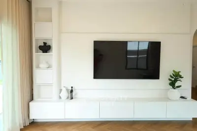 Modern living room with sleek TV setup and elegant decor
