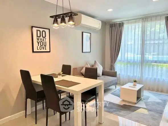 Modern living room with stylish dining area and cozy seating, featuring elegant decor and natural light.