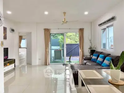 Spacious modern living room with sleek design and natural light, featuring a cozy seating area and dining space.