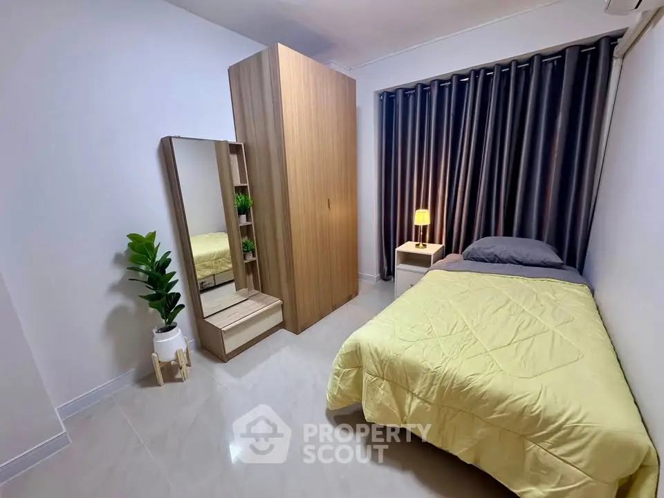 Cozy bedroom with modern wardrobe and stylish decor in a well-lit apartment.