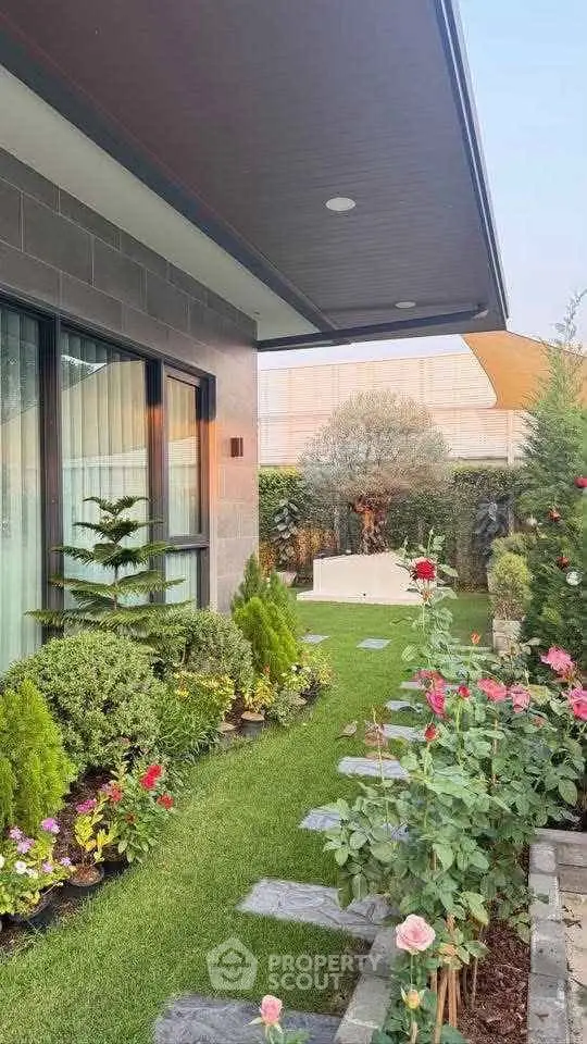 Charming garden view with lush greenery and vibrant flowers enhancing modern home exterior.