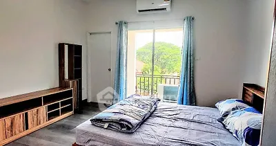 Bright bedroom with balcony view and modern furnishings