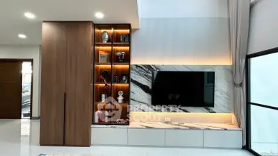 Modern living room with stylish built-in shelves and marble TV wall