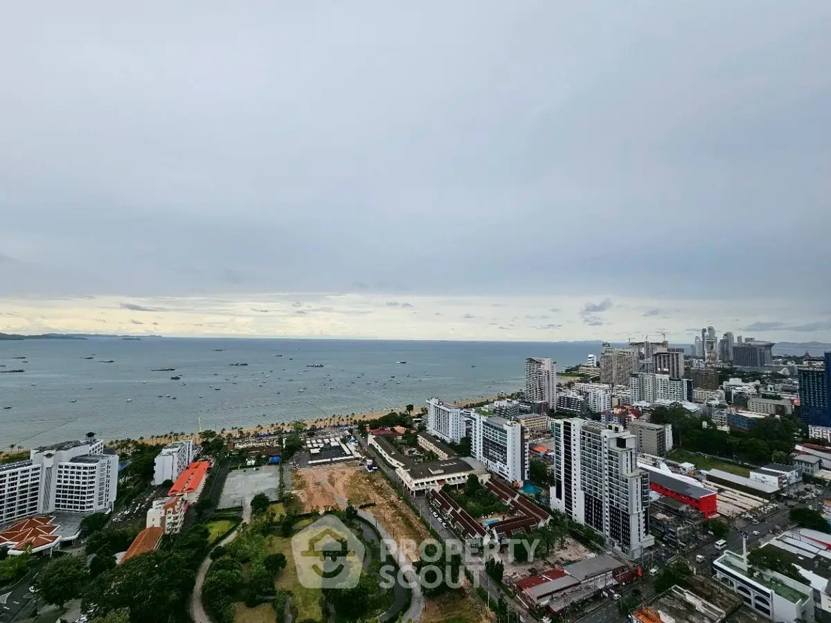 Stunning panoramic view of coastal cityscape with ocean horizon, ideal for luxury real estate investment.