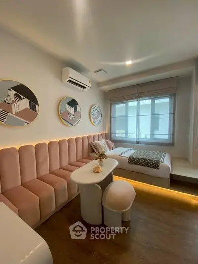 Stylish modern living room with unique wall art and cozy seating area, perfect for relaxation.