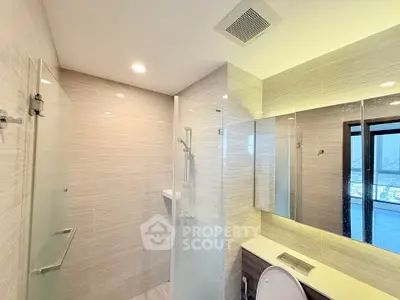 Modern bathroom with glass shower and city view window