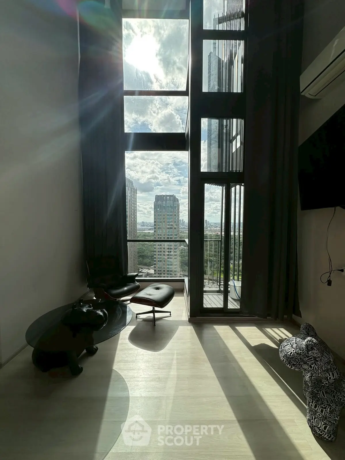 Stunning high-rise apartment with floor-to-ceiling windows and breathtaking city view.