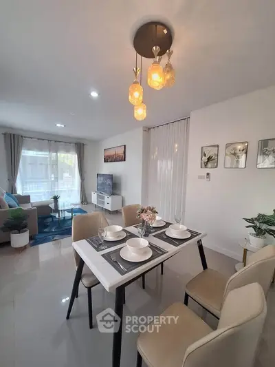 Modern living and dining area with elegant lighting and stylish decor