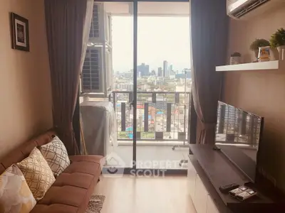 Cozy living room with city view from balcony, featuring modern decor and comfortable seating.