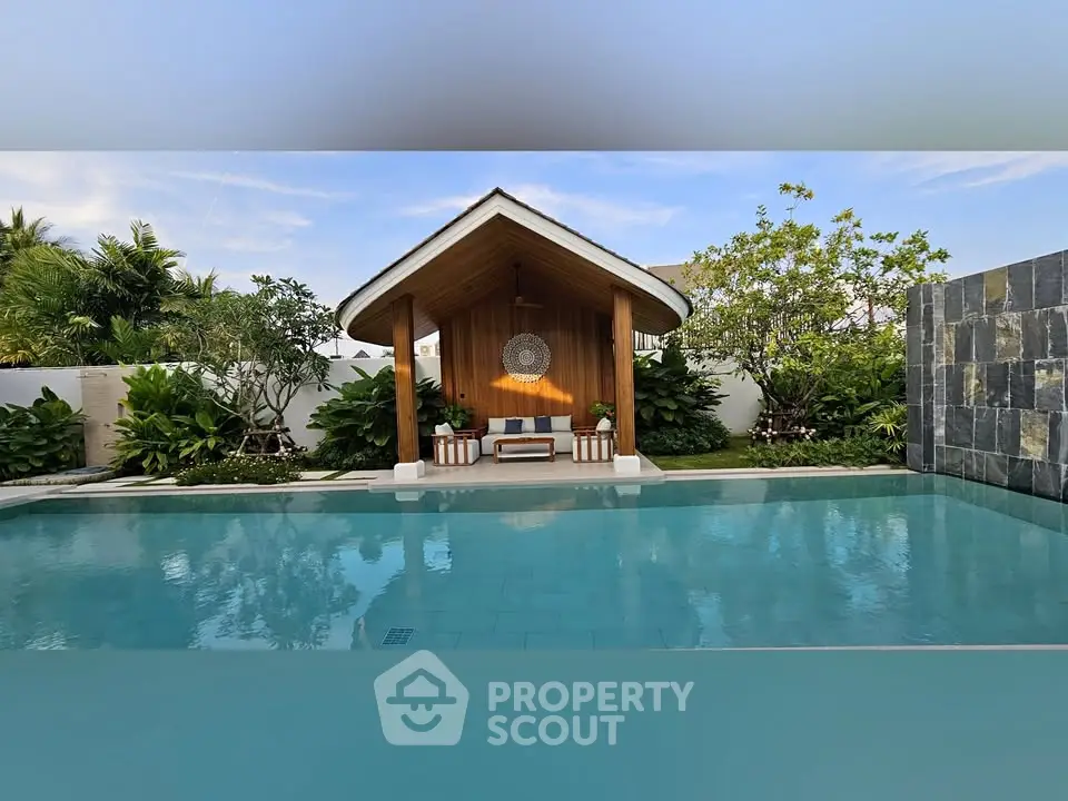 Luxurious outdoor pool with stylish cabana and lush greenery, perfect for relaxation and entertainment.