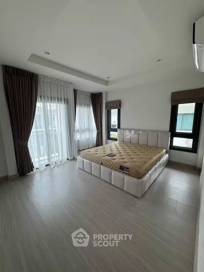 Spacious bedroom with large windows and modern decor