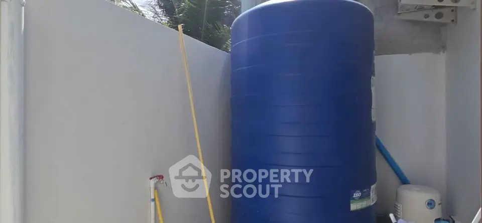 Outdoor water storage tank in a residential property corner