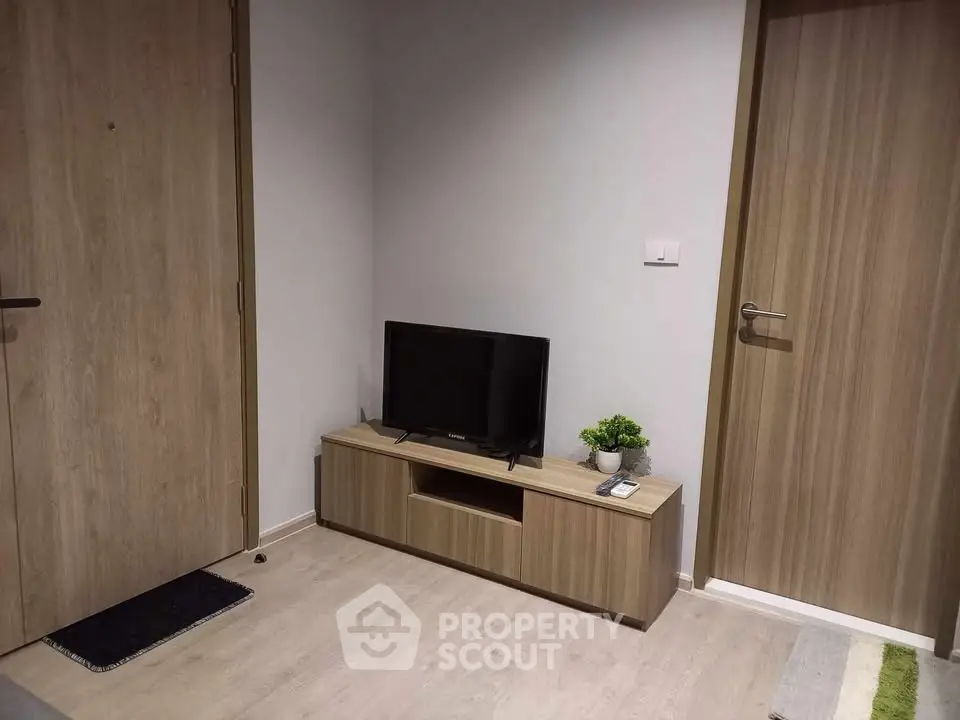 Modern living room corner with TV on wooden stand and stylish decor