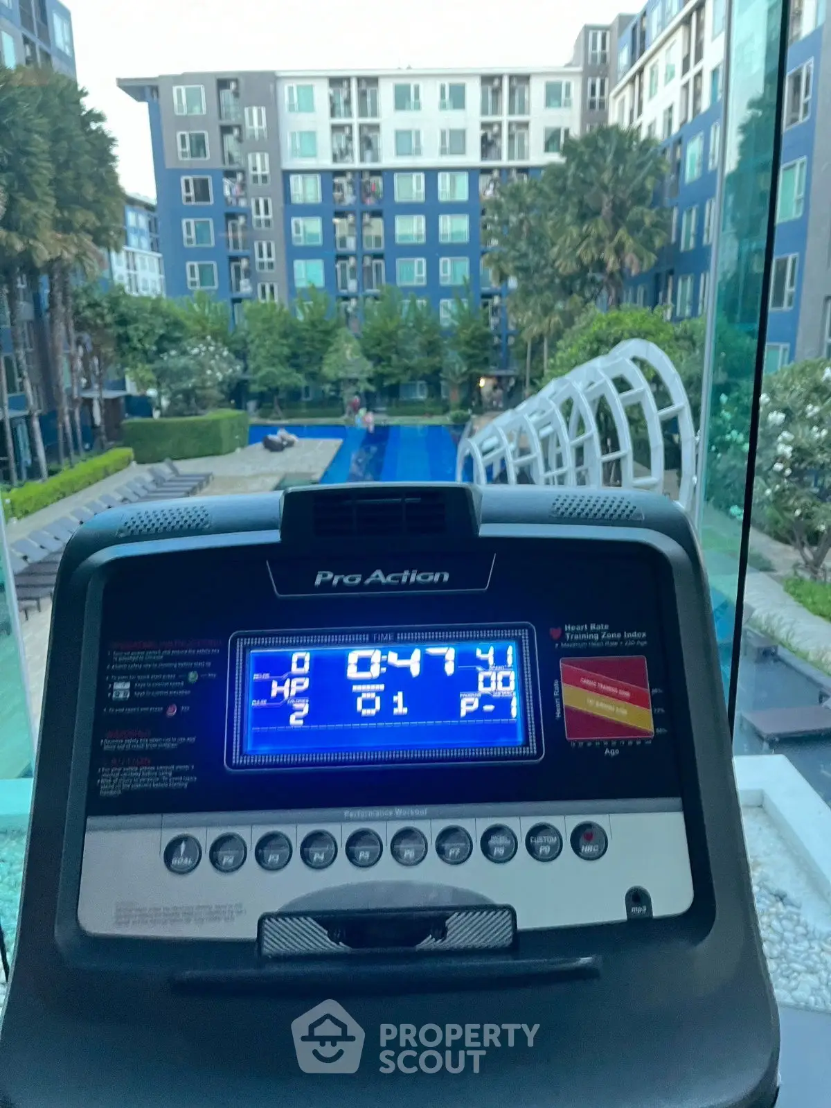 Modern gym with pool view in luxury apartment complex