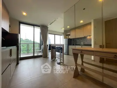 Modern open-layout kitchen with balcony view in stylish apartment