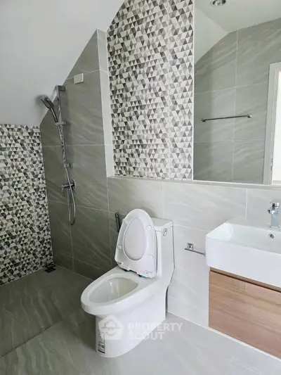 Modern bathroom with stylish geometric tiles and sleek fixtures