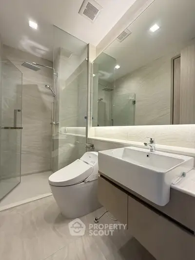 Modern bathroom with glass shower and sleek fixtures