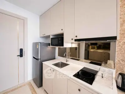 Modern kitchen with sleek cabinetry, built-in appliances, and elegant countertop in a compact layout.
