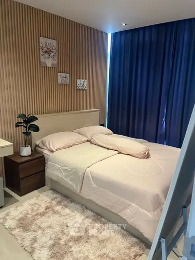 Cozy modern bedroom with wooden accents and soft lighting, perfect for relaxation.