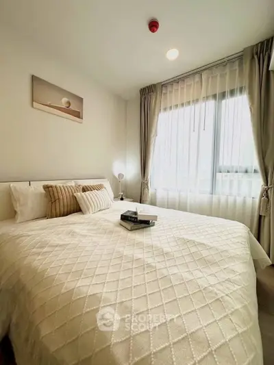 Cozy bedroom with elegant decor and large window for natural light