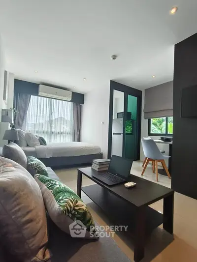 Modern studio apartment with open layout, featuring a cozy living area and bedroom, ideal for urban living.