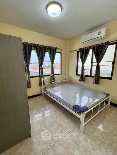 Cozy bedroom with natural light and air conditioning in a modern apartment