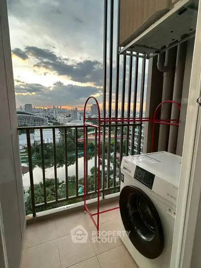 Charming balcony with washer and stunning city view at sunset