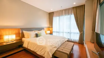 Elegant bedroom with large window and cozy lighting in modern apartment.