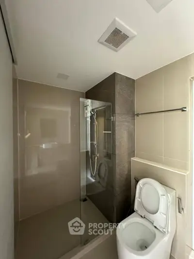 Modern bathroom with glass shower and sleek toilet design