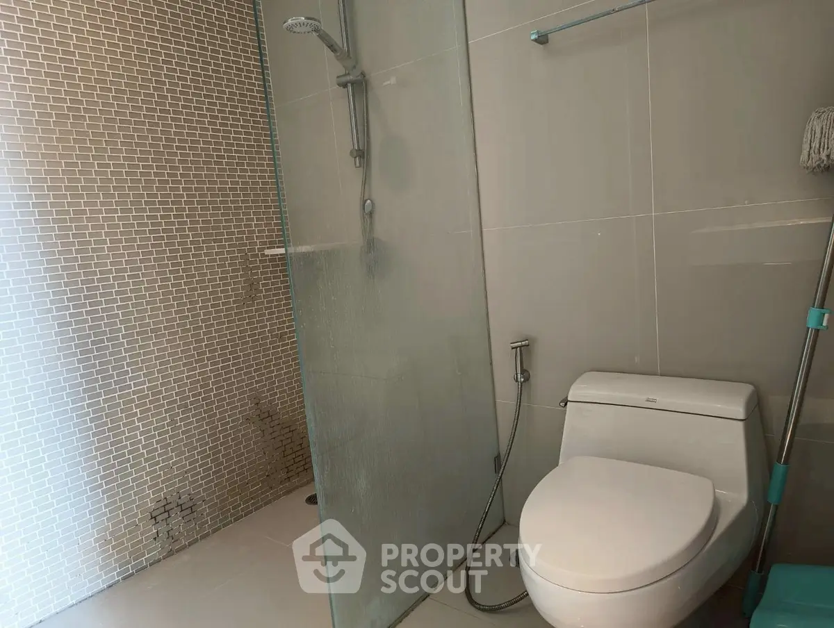 Modern bathroom with glass shower and sleek toilet design