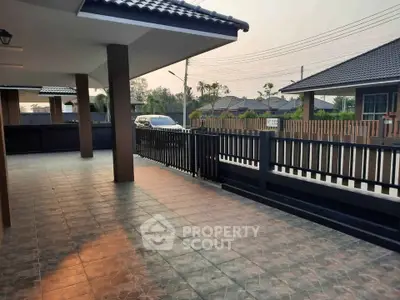 Spacious covered patio with tiled flooring in a modern residential area.