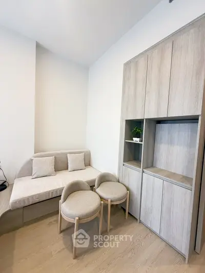 Modern minimalist living room with cozy seating and sleek storage solutions