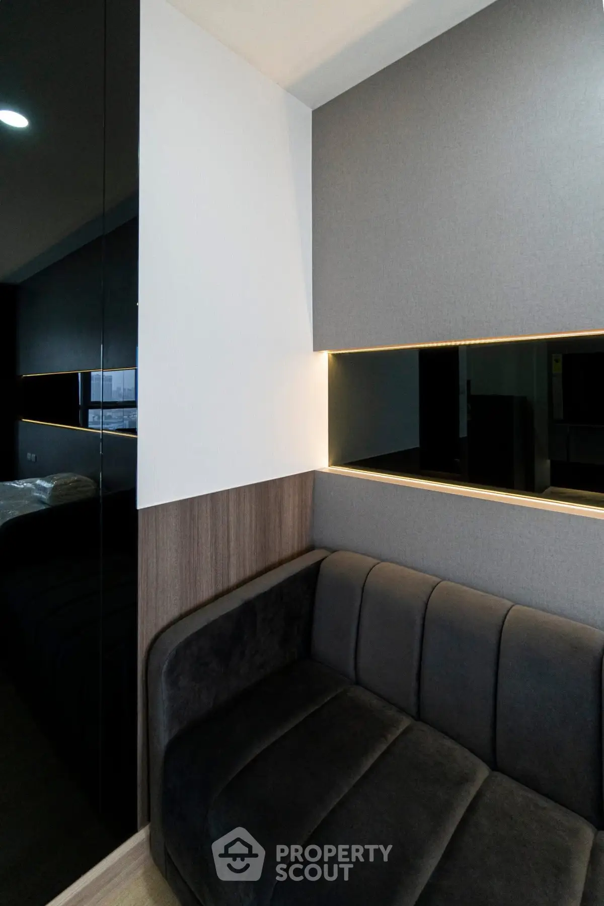 Modern interior with sleek black sofa and ambient lighting