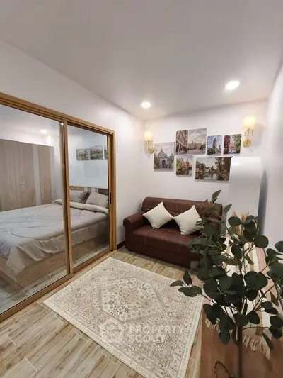 Cozy living room with elegant decor and sliding glass doors leading to a bedroom, perfect for modern living.