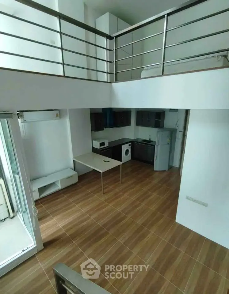 Modern loft apartment with open layout, featuring a compact kitchen and mezzanine bedroom.