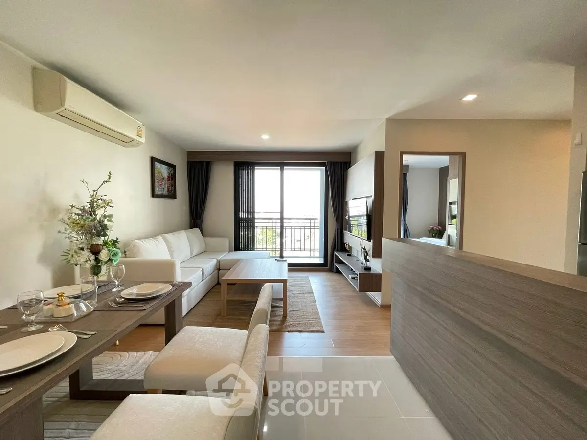 Modern open-plan living room with stylish decor and natural light