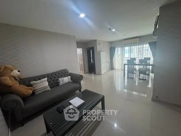 Spacious living room with modern decor and ample natural light.